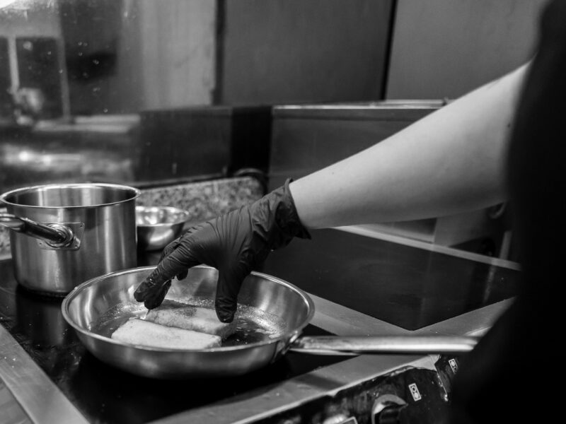 Close up,Of,A,Hand,In,A,Black,Glove,Cooking,Bread